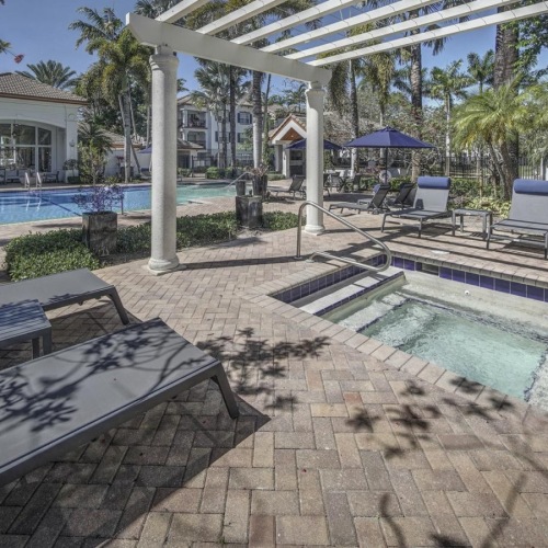 Relax and unwind poolside hot tub next to outdoor swimming pool