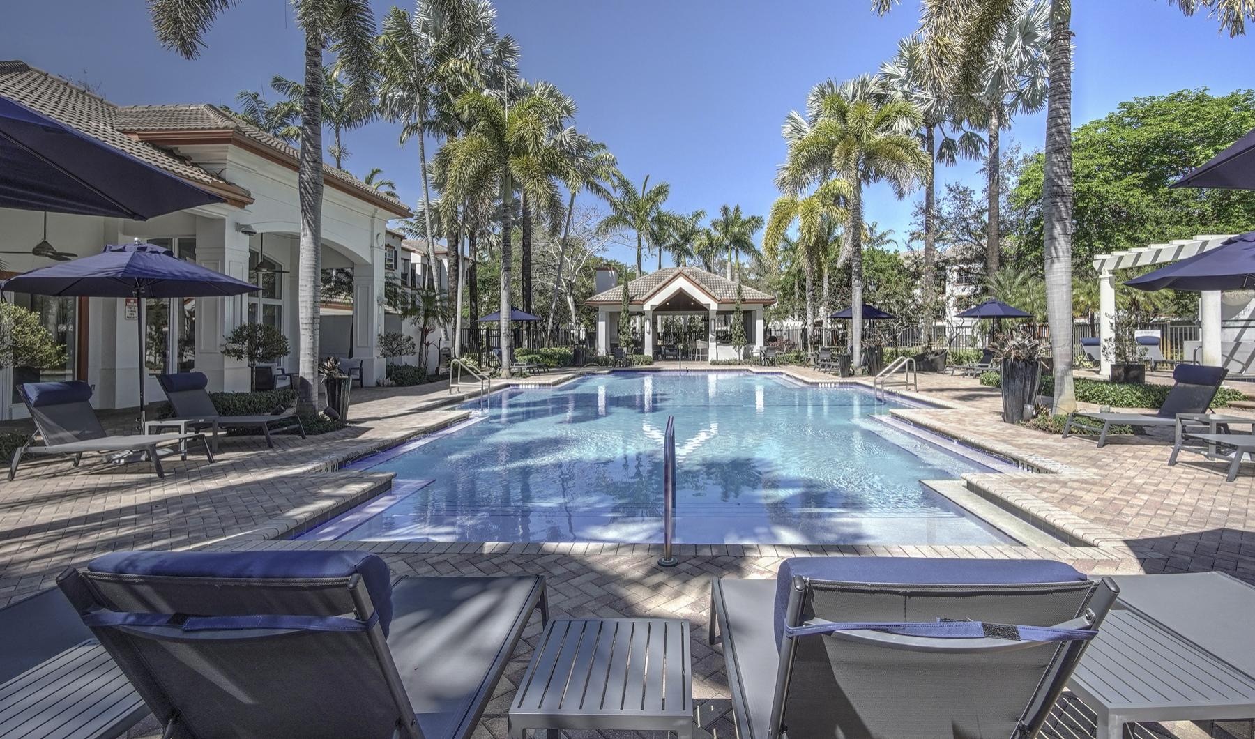 Resort-style swimming pool pool with lounge chairs